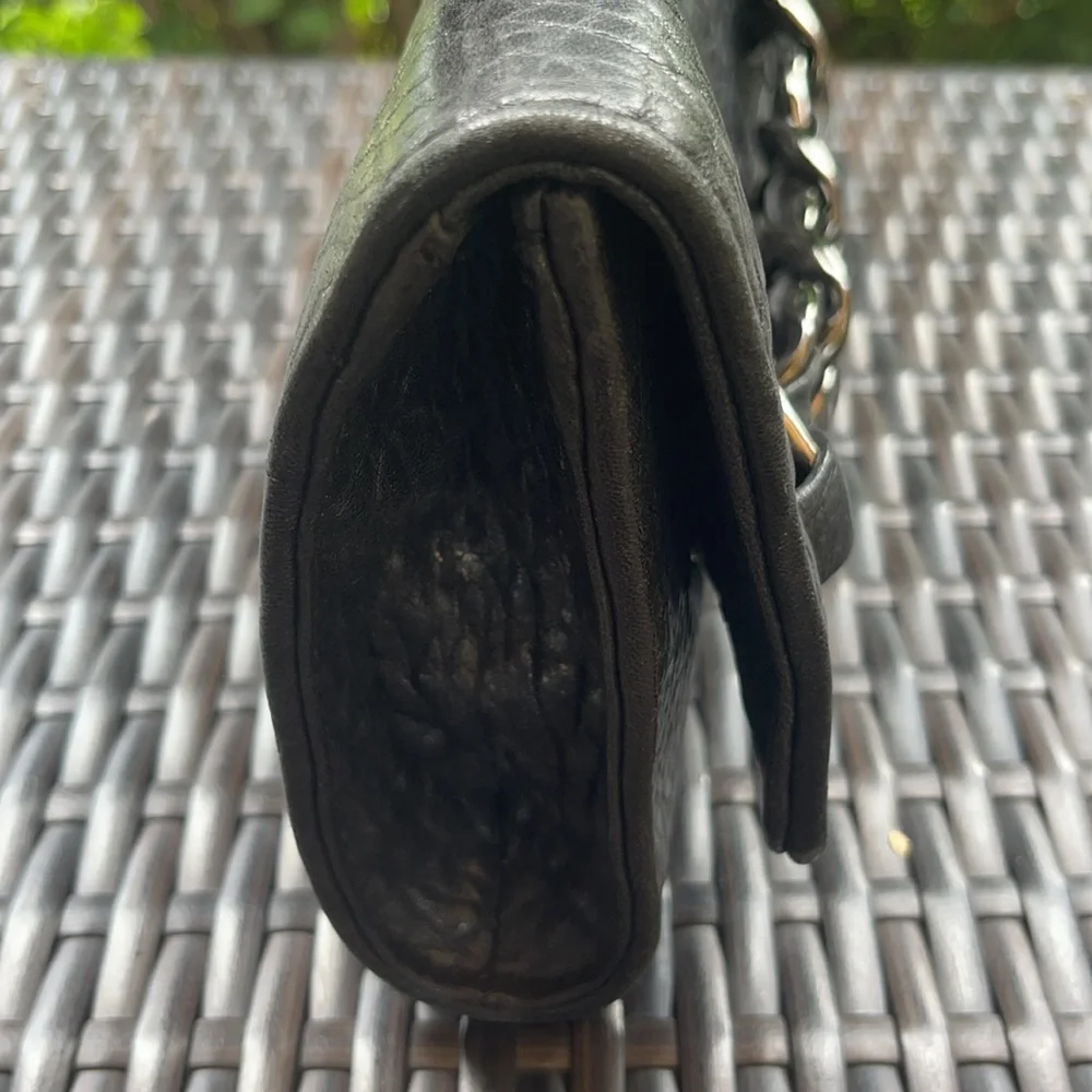 Michael kors Pebbled leather MK clutch with gun metal zipper.
